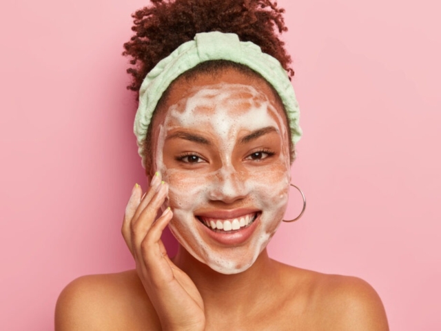 woman with cleanser on face