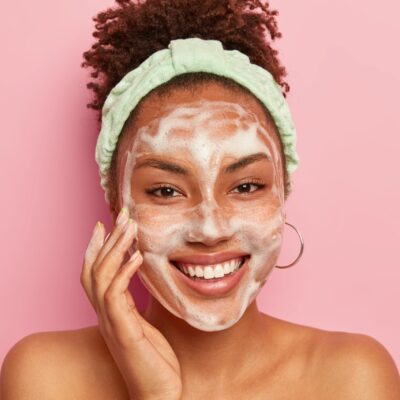 woman with cleanser on face